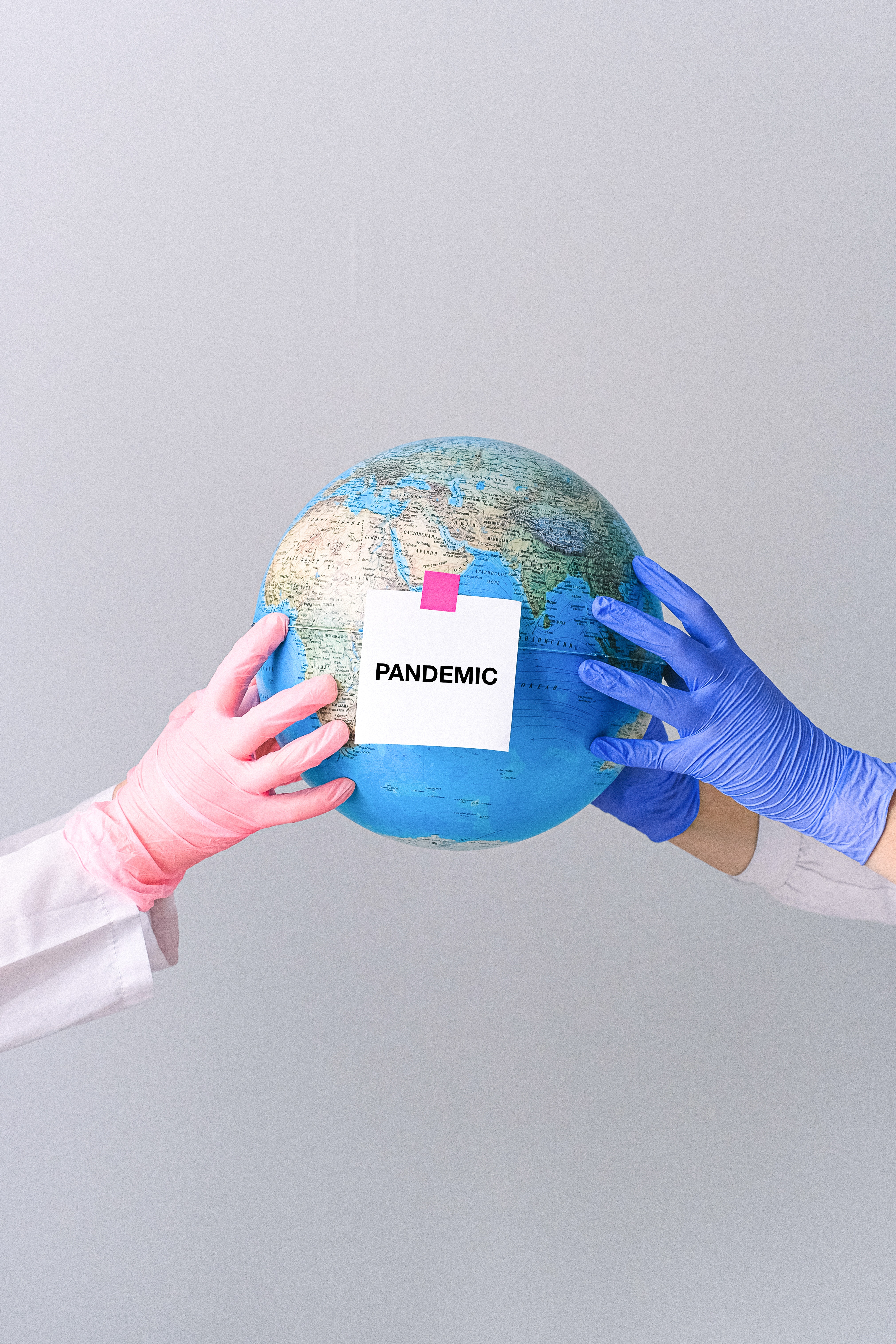 hands-with-latex-gloves-holding-a-globe-4167580